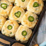 Closeup of cheddar jalapeno biscuits in cast iron pan.
