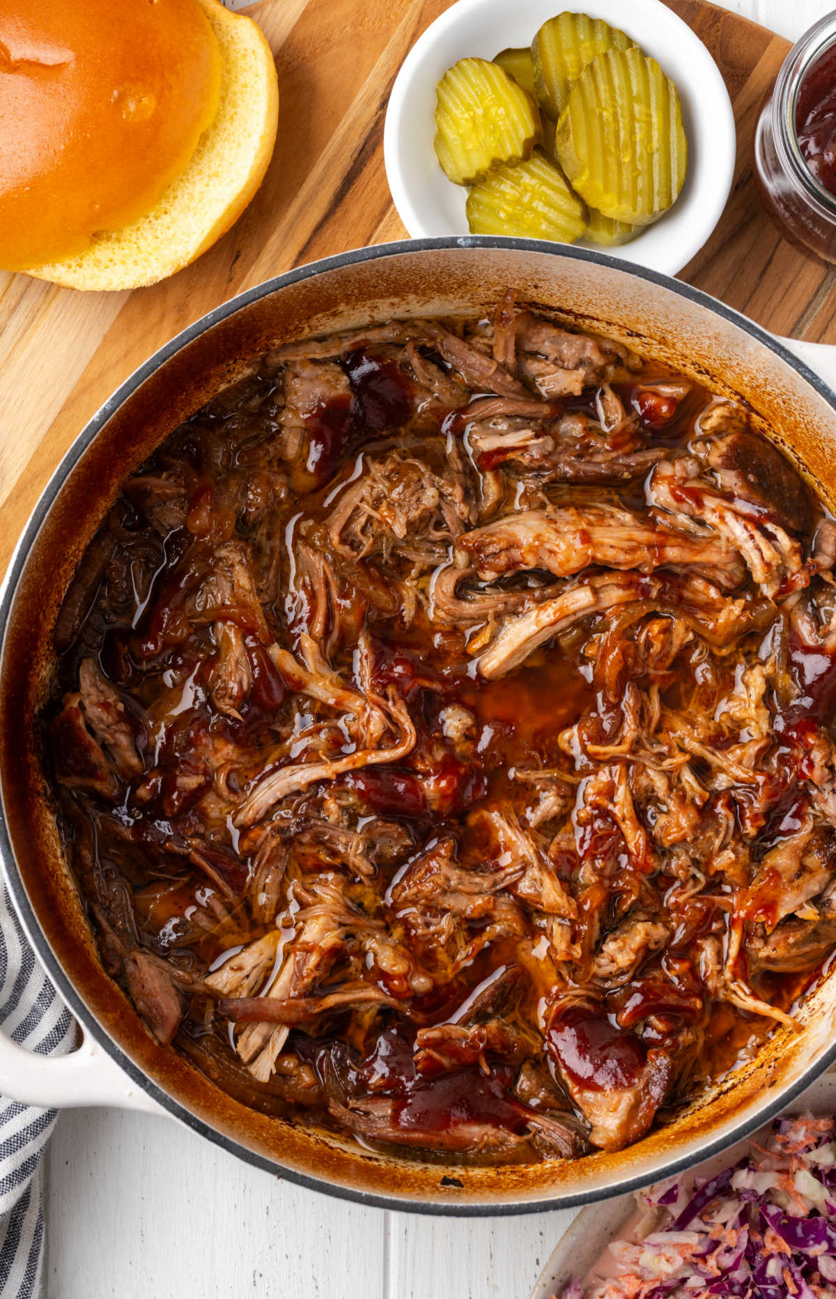 Shredded pork in Dutch oven with barbecue sauce.