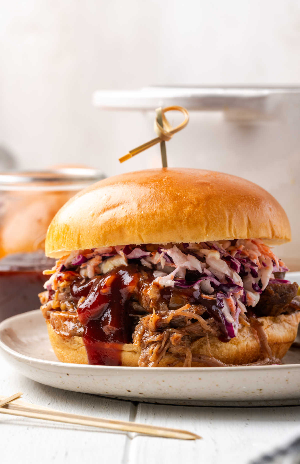 BBQ pulled pork sandwich with coleslaw on brioche bun.