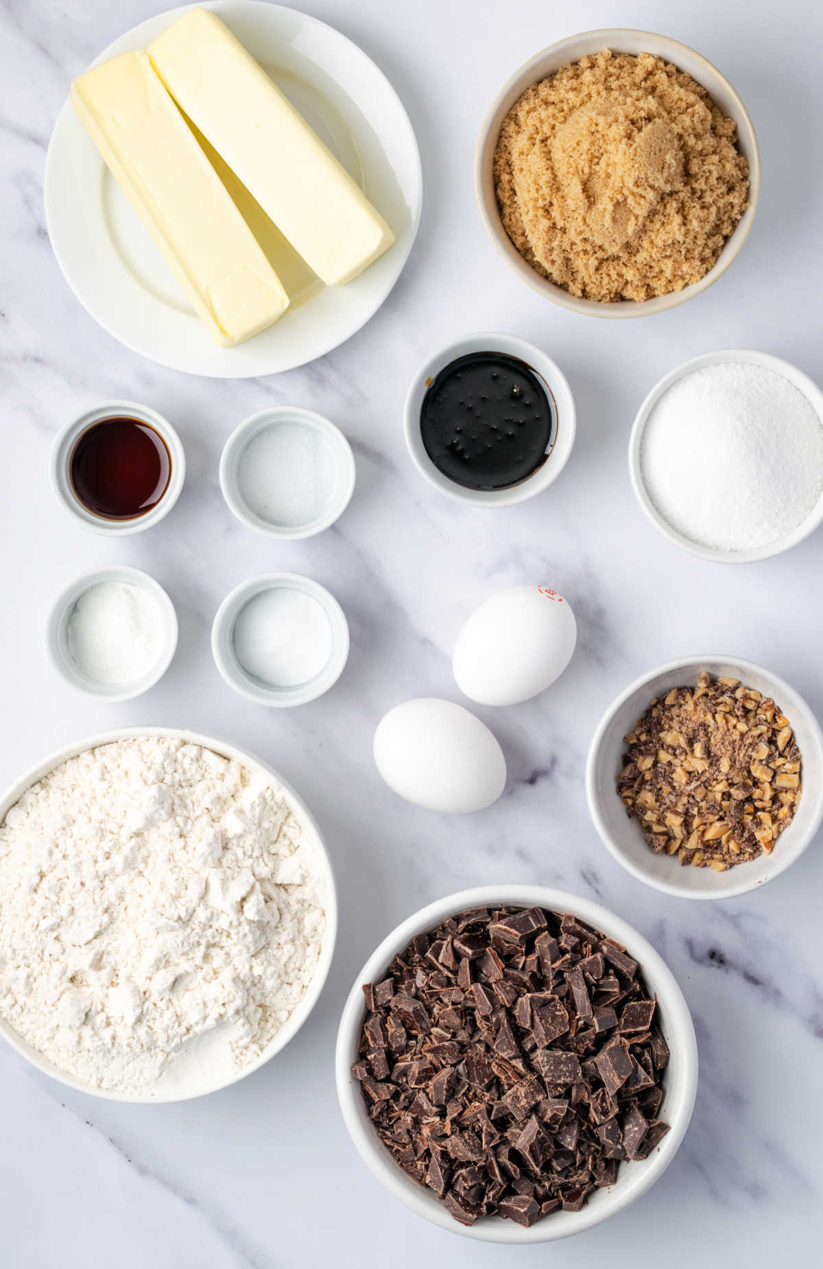 Ingredients in small white bowls for cookies.