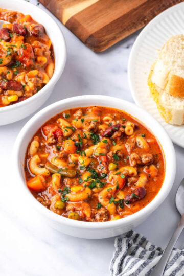 Beef vegetable soup in white bowls.
