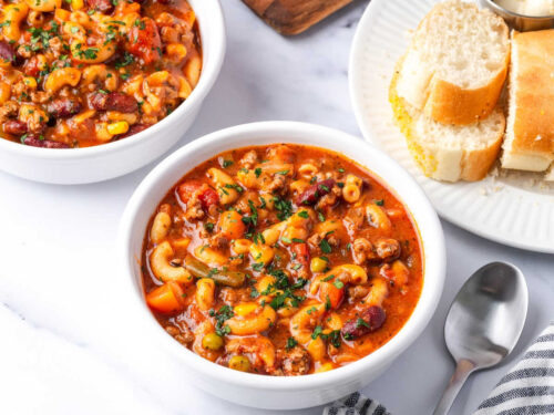 Beef vegetable soup in white bowls.