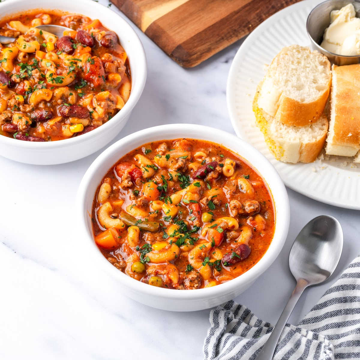 Beef vegetable soup in white bowls.