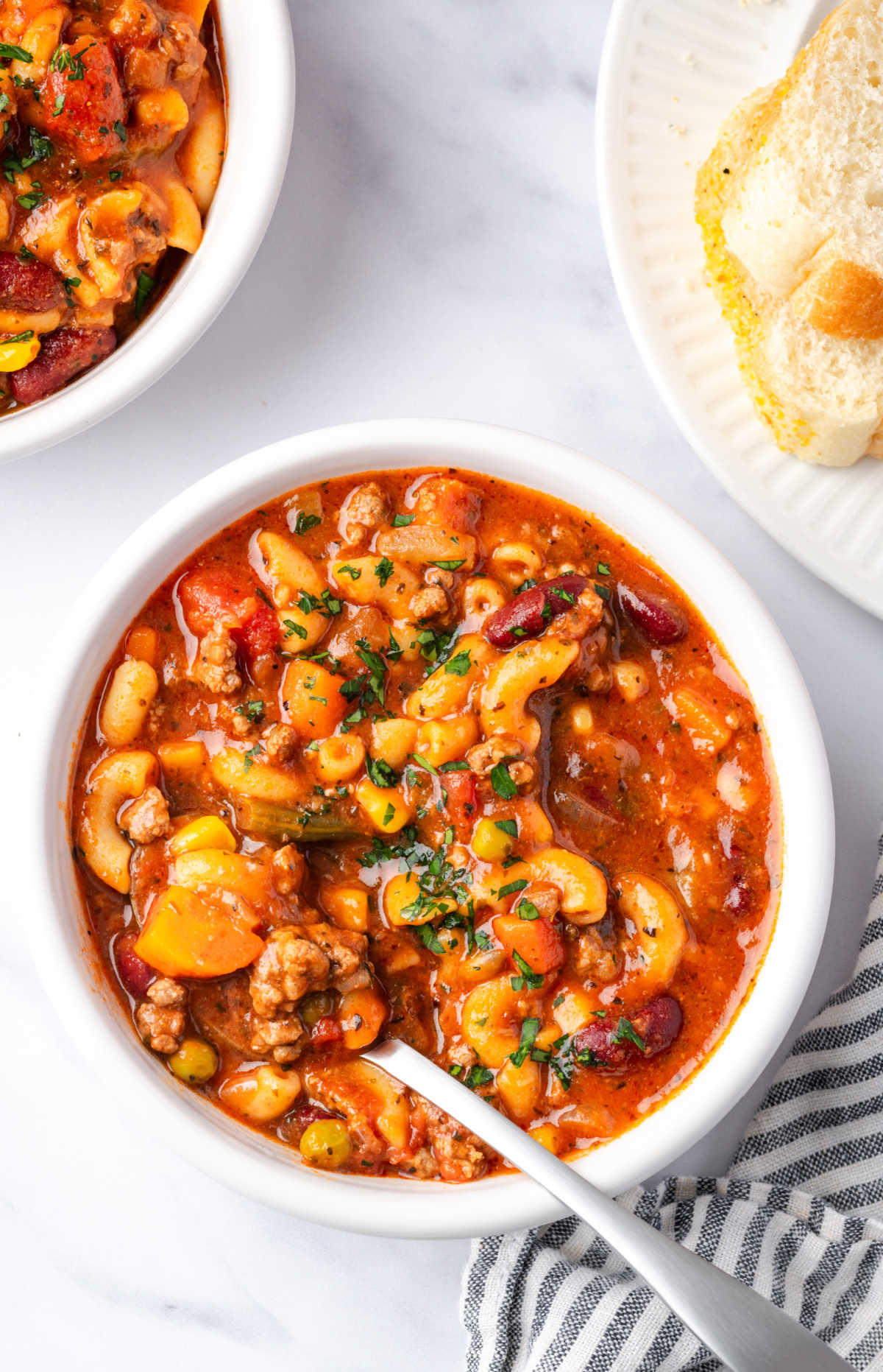 Bowl of hamburger soup with elbow macaroni and vegetables.