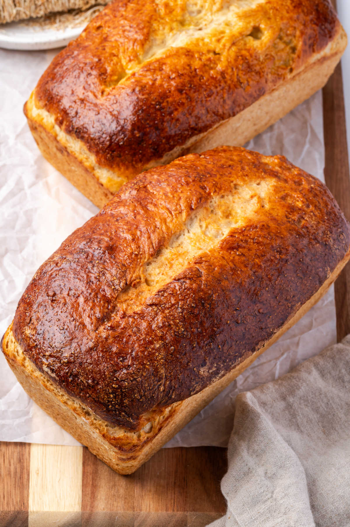 Close up of loaves of bread on cutting board.