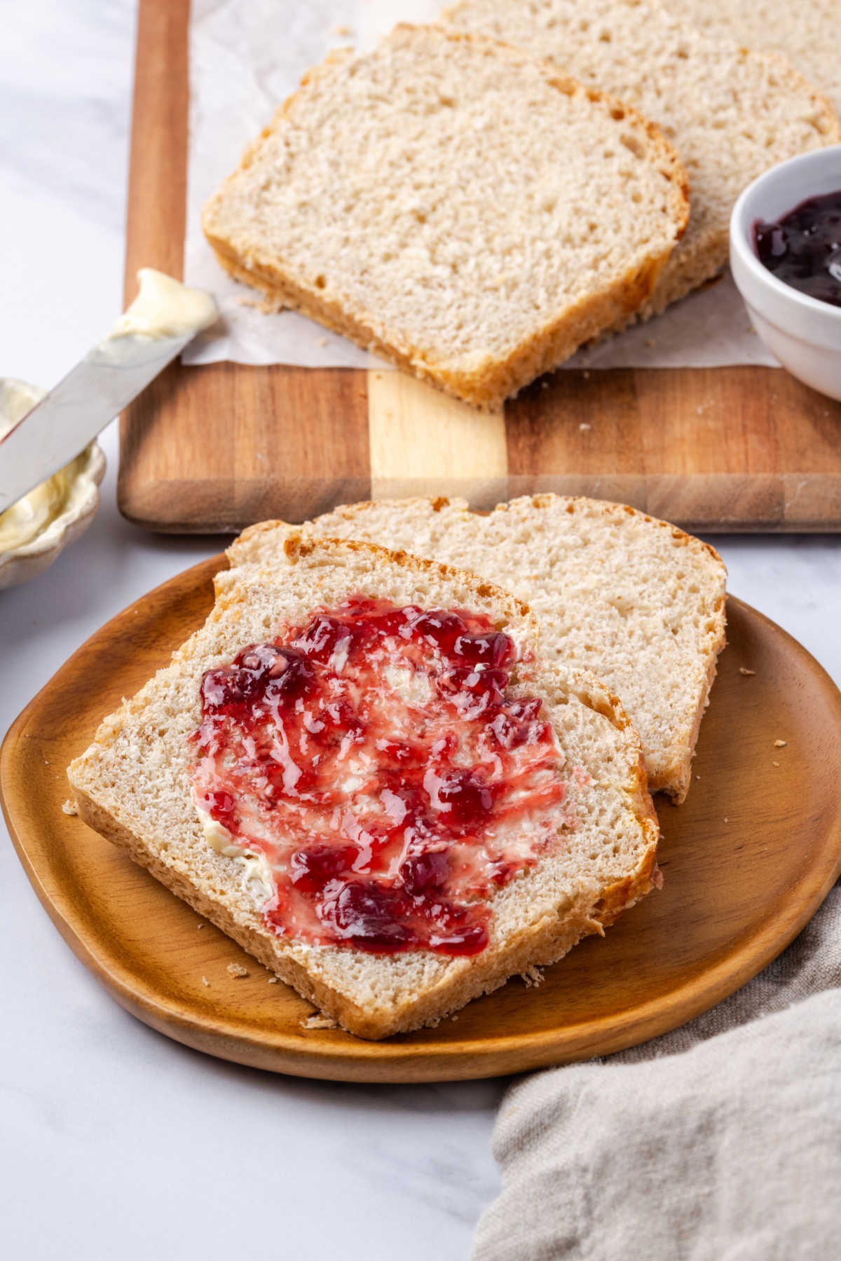 Sliced of bread on plate with jam.