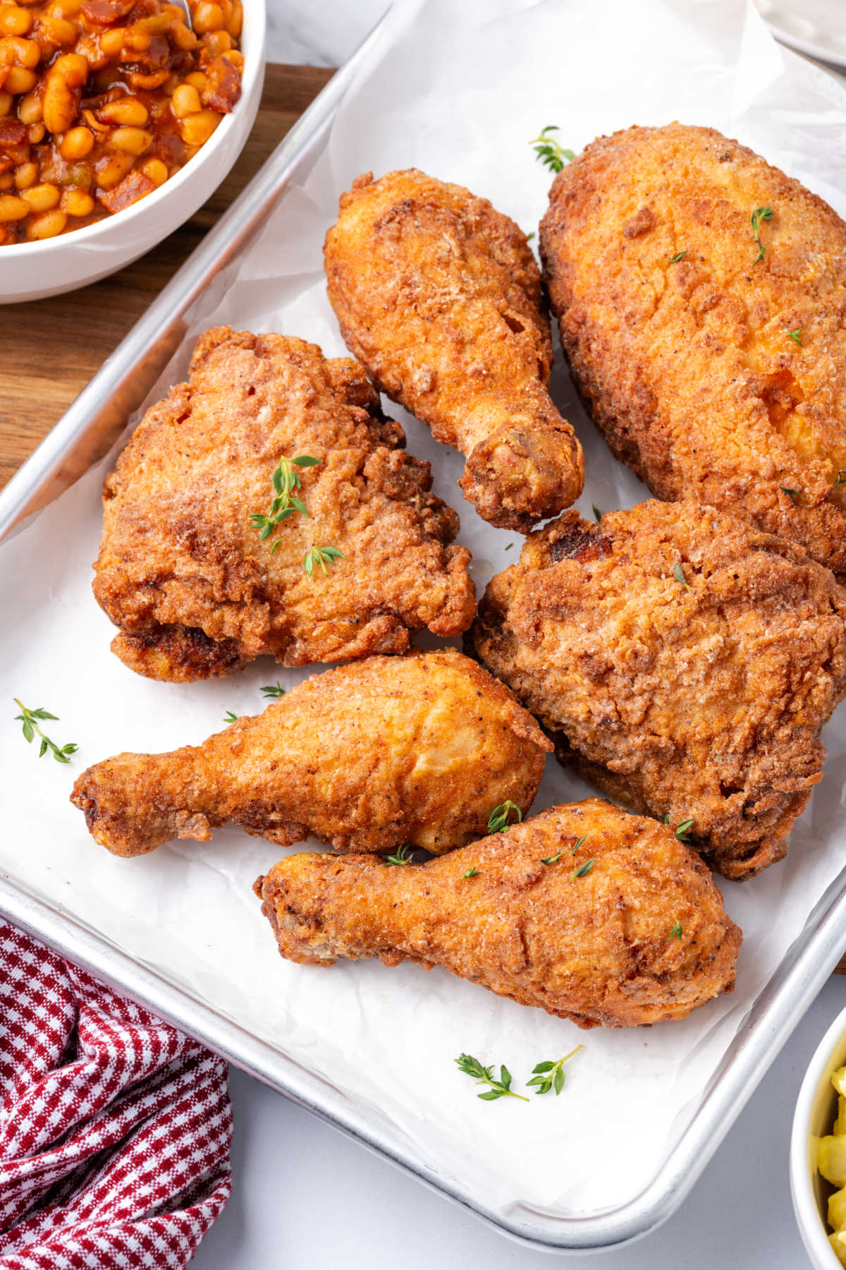 Fried chicken pieces on sheet pan.