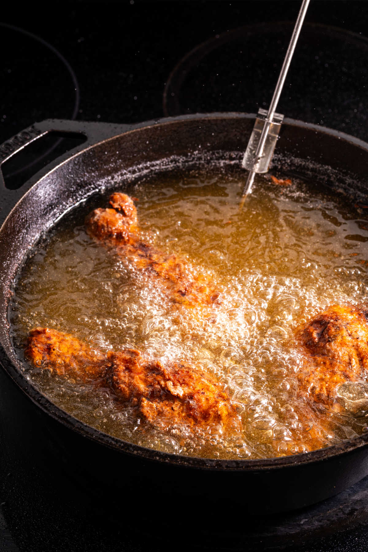 Frying chicken in cast iron Dutch oven.
