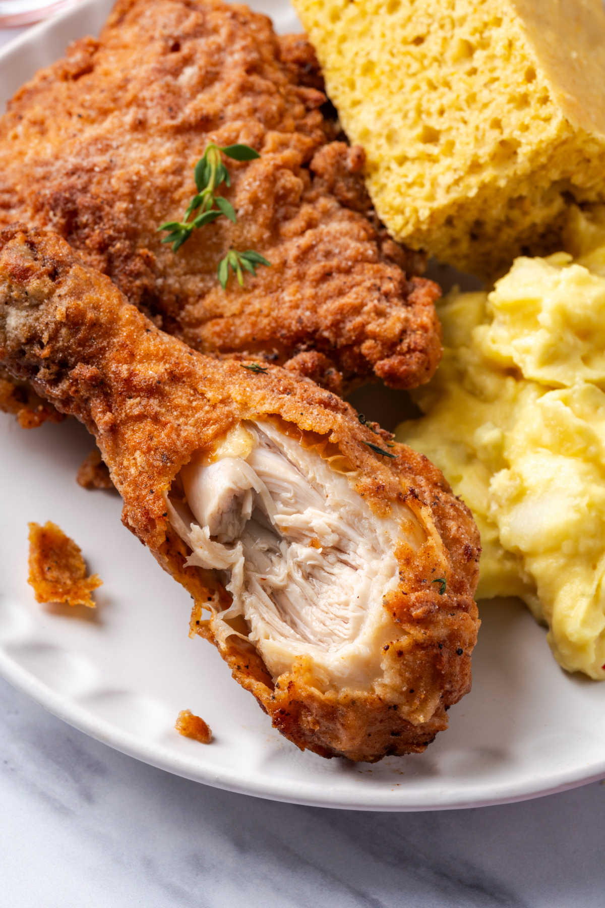 Fried chicken on plate with bite out of it.