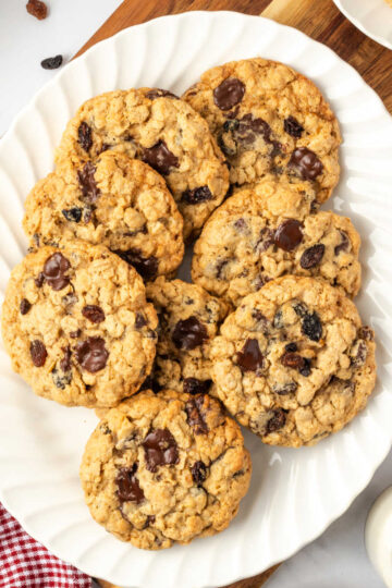 Oatmeal raisin cookies on small white plate.