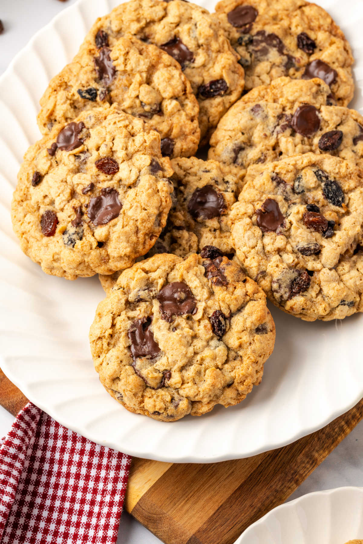 Oatmeal raisin cookies stacked on small white plate.