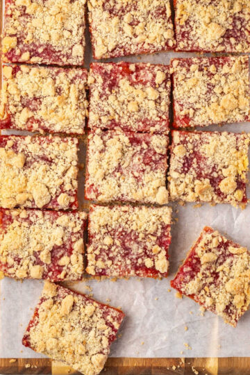 Peach bars cut up on wood cutting board.
