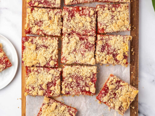 Peach bars cut up on wood cutting board.