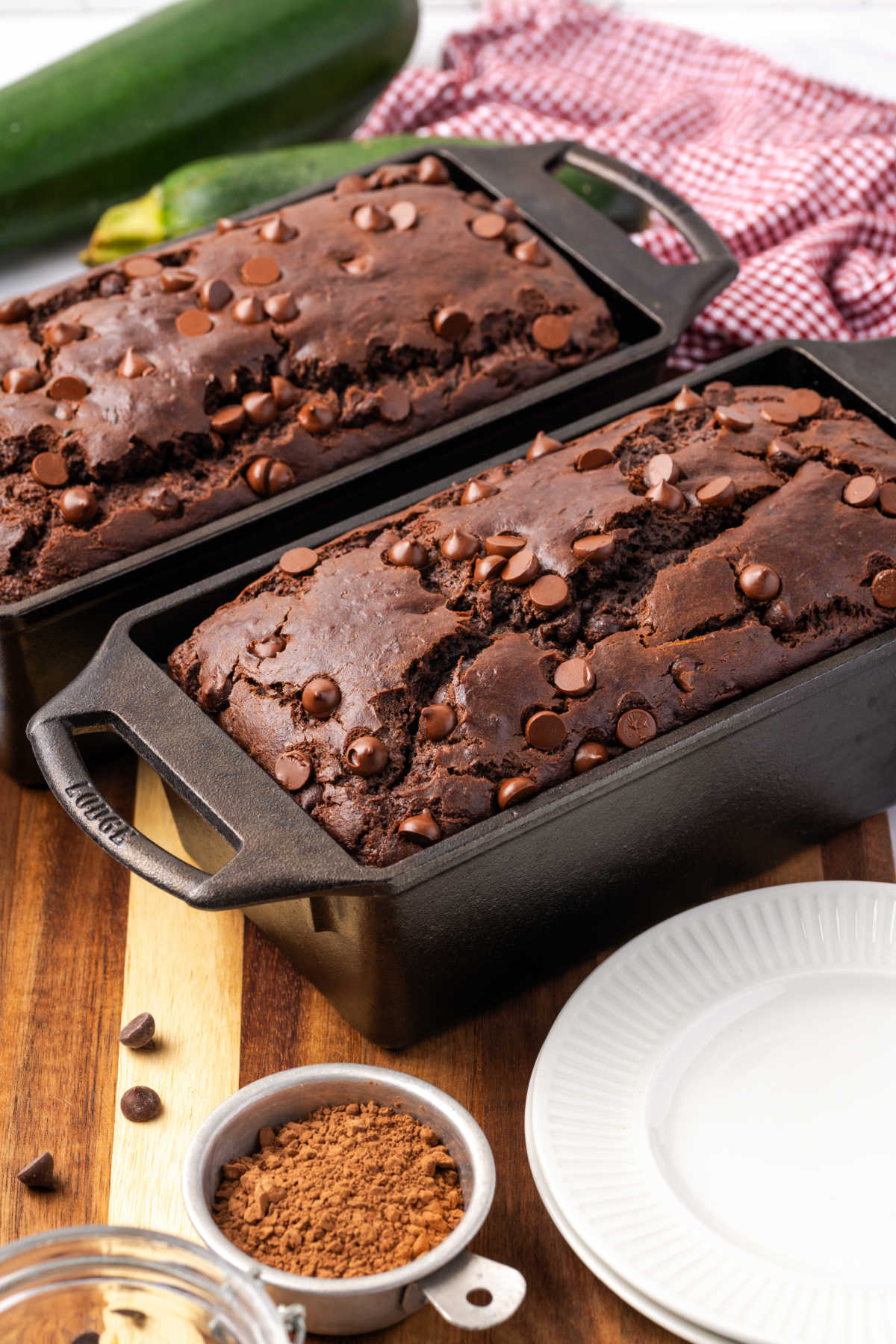 Two loaves of chocolate zucchini bread in cast iron loaf pans.