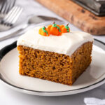 Square of pumpkin cake on small white plate.