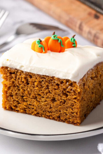 Square of pumpkin cake on small white plate.