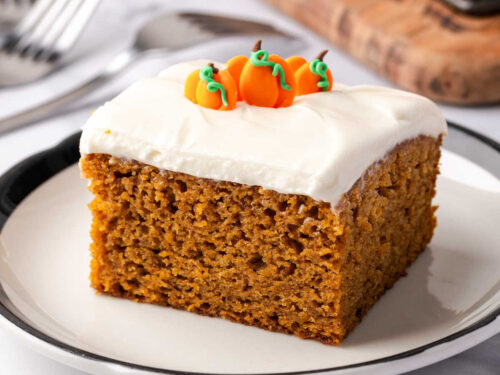 Square of pumpkin cake on small white plate.