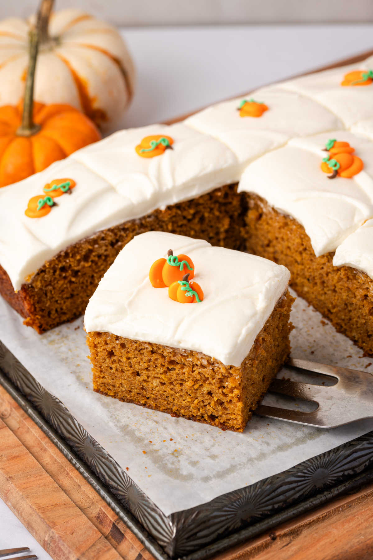 Sheet pan cake with frosting and pumpkin candies.