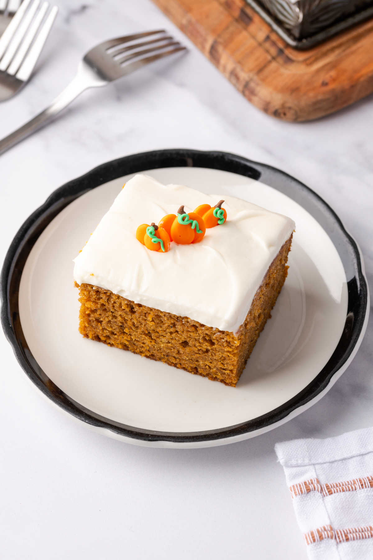 Square of pumpkin cake on small white plate.